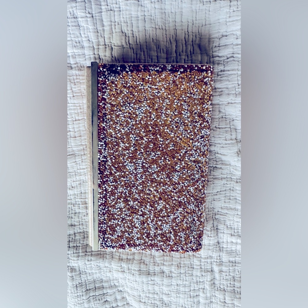 Glamorous gold and silver glitter-encrusted clutch with a metallic side trim.